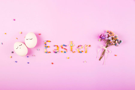 Easter creative layout with the word Easter made of flowers, a bouquet of small flowers and cute...
