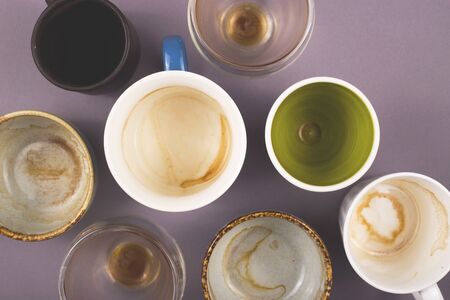 Several empty cups of coffee viewed from above on gray table. Top view layout.の写真素材