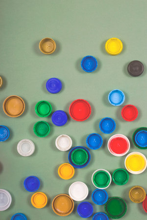 A lot of multi-colored caps from plastic bottles for recycling. Zero waste concept layout.