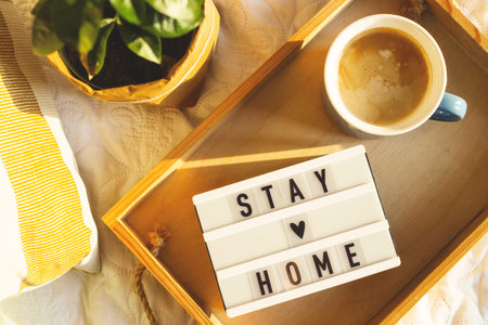 Stay home concept of self-isolation during the Covid-19 coronavirus pandemic. Cozy light home interior.の写真素材