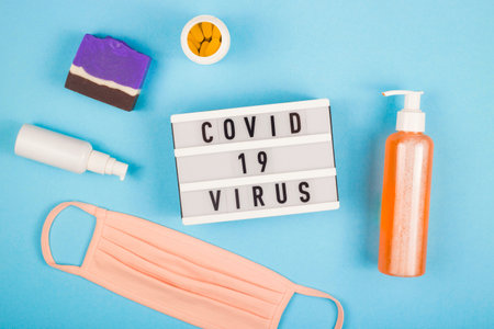 Medical mask on layout of the coronovirus. Covid 19 inscription. Top view. Quarantine concept.