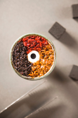 Bowl of the hookah is filled with tobacco mixed with different flavors for Smoking and leisure....