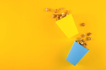 Popcorn for home cinema on yellow background. Top viewの写真素材