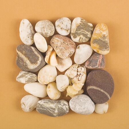 Natural sea stones on a brown background. Top view.の写真素材