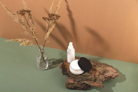 Natural personal care products with shadows of dried flowers.の写真素材