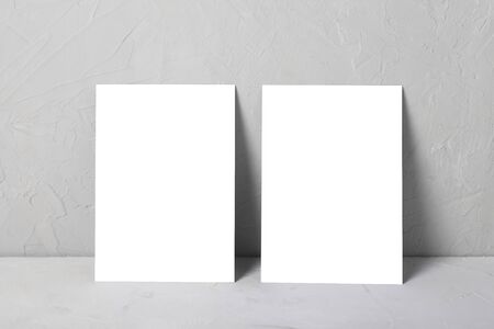 Greeting card mock-up on gray next with eucalyptus.の写真素材