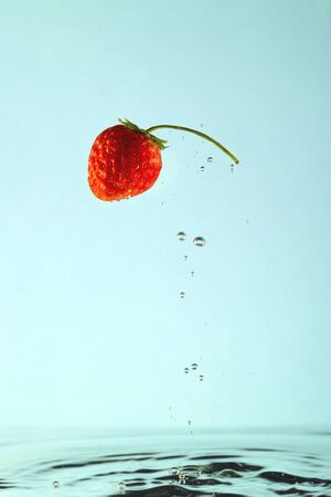 Red strawberry with bulbs in clear water.の写真素材