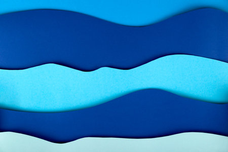 Blue background paper art sea waves with copy space.