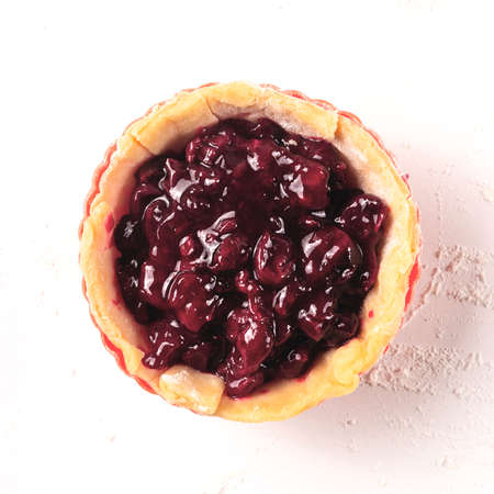 Cherry mini pie is almost ready to bake. Cooking processの写真素材