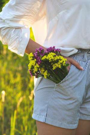 The concept of closeness to nature - flowers in the pocketの写真素材