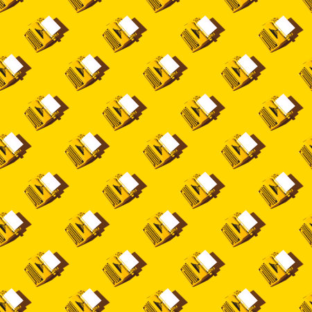 Yellow bright typewriter on a yellow background. Creativity concept