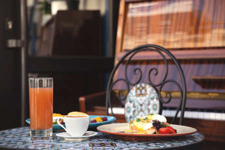 Beautiful healthy breakfast in a restaurant for two next to the pianoの写真素材