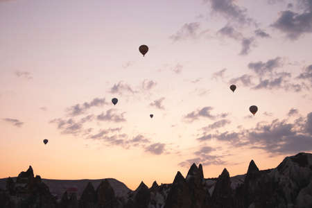 Flying balloons against the background of the colored dawn skyの写真素材