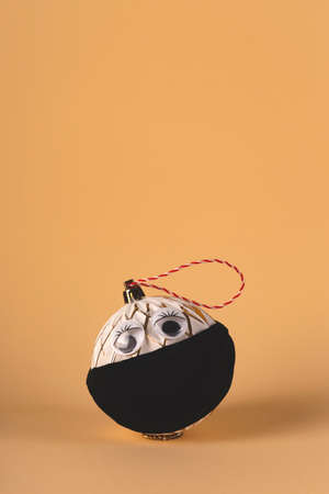 Christmas tree ball in a protective mask from the virusの写真素材