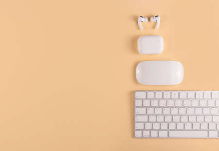 A neutral colored workplace with modern personal equipment and gadgetsの写真素材