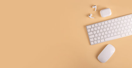 A neutral colored workplace with modern personal equipment and gadgets