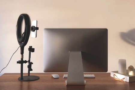 Home bloggers workplace in an apartment against a light wall with shadowsの写真素材