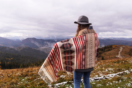 Wanderlust concept. Woman in boho style in the mountains