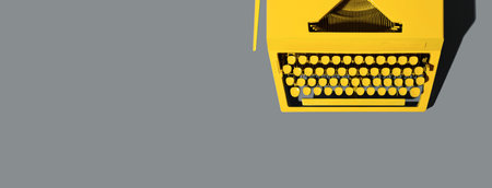 Yellow bright typewriter on gray background. Color of the year 2021の写真素材