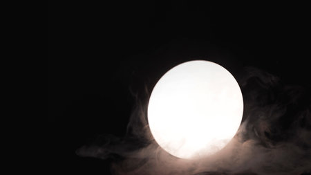 Surreal smoke with reflection in a round mirrorの写真素材