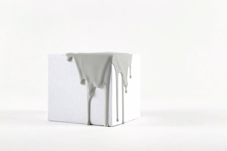 White cube with smudges of gray paint color of the year 2021の写真素材