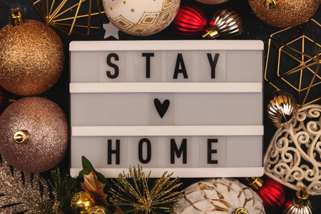 Stay Home written on lightbox among Christmas decorationsの写真素材