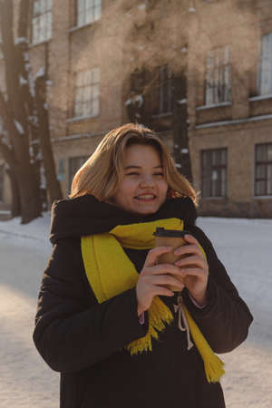 Beautiful happy blonde girl with a cup of coffeeの写真素材