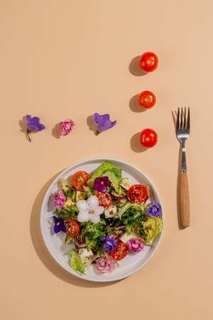 Beautiful healthy spring salad decorated with flowersの写真素材