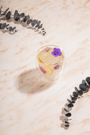 Modern water glass with flowers in minimalism styleの写真素材