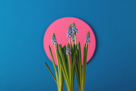 Modern spring card with blue flowers on the background of the dawn sun made of paper. Paper art with...