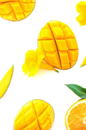 Ripe chopped mango on white with yellow flowers. Vegan beautiful dessert layout on white. Isolated imageの写真素材