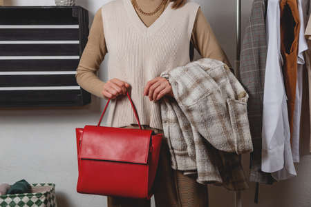 Woman fashion stylist and shopper in fitting room. Returning purchases offlineの写真素材