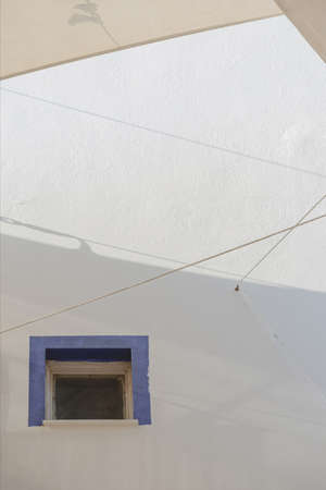 A white building with blue window frames in the Greek style. Travel and architecture conceptの写真素材