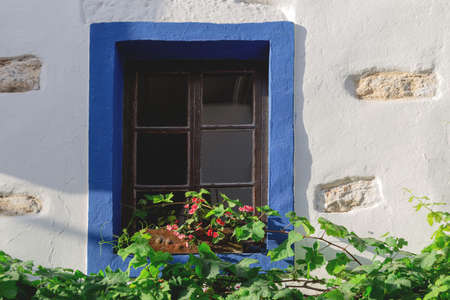 A white building with blue window frames. Travel and architecture conceptの写真素材