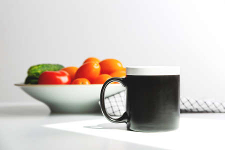 Black coffee mug mockup on kitchen table. Cup mock up for designの写真素材