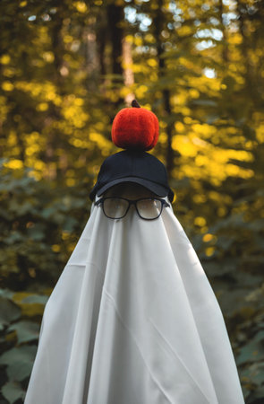 Halloween ghost in forest. Festive creative concept