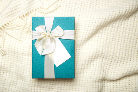 Gift box with empty white blank gift tag mock up. Christmas, birthday or wedding gift.の写真素材