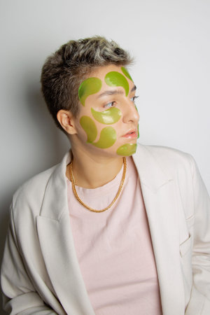Woman with many cosmetic collagen patches all over her face. Concept art portrait. Antistress and...