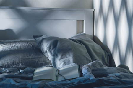 Open diary to write on the bed with blue textiles in the moonlight. Evening rituals for mental health.の写真素材