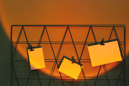Cards mockups on moodboard with reminders at freelance workplace in sunset lamp projection.の写真素材