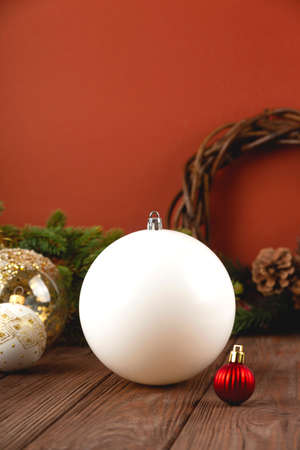 White Christmas Ornament mockup on wooden table with festive decorations. Christmas ball mock up.の写真素材