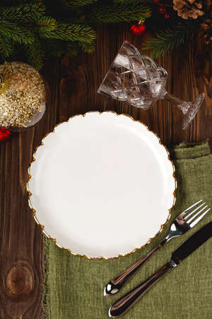 Empty white plate mock up at served Christmas table among decorations. Top view layout.の写真素材