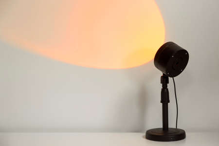 Electric sunset lamp for atmospheric, warm yellow illumination at home.の写真素材