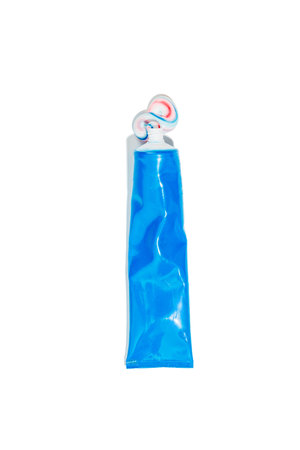 Dental blue tube with squeezed out toothpaste in white, red and blue lies on white background....