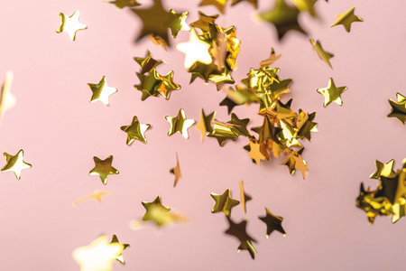 Background with flying gold confetti stars. Pink background. Wallpaper.の写真素材