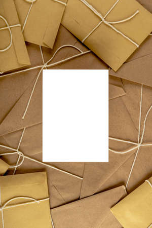 Christmas card mockup. Empty postcard mock up on lots of craft envelopes and letters.の写真素材