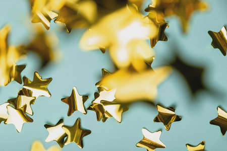 Background with flying gold confetti stars. Blue background. Wallpaperの写真素材