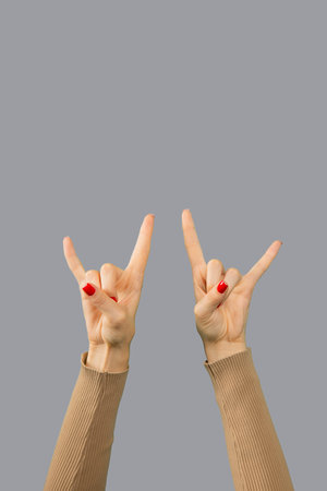 Signs of horns from two female hands isolated.の写真素材