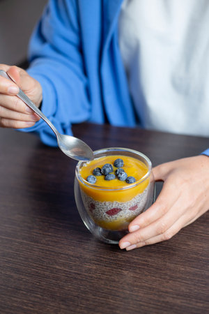 Healthy vegan dessert - chia pudding with mango and berries. Vegan eating.の写真素材