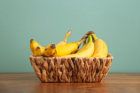 Bananas in wicker basket at home.の写真素材